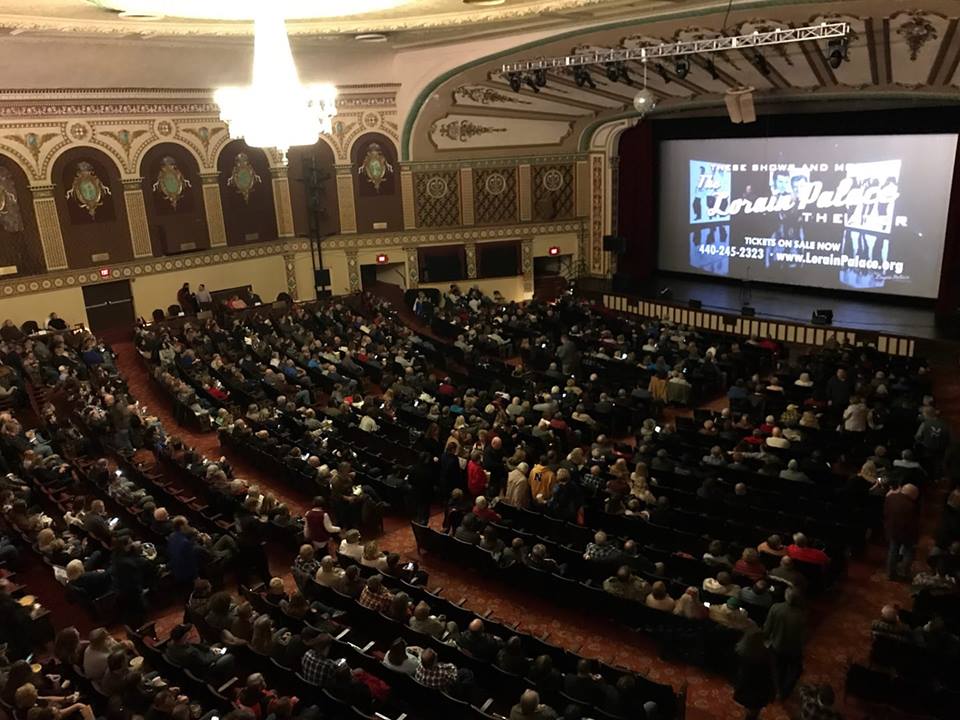A large crowd of people in an auditorium.