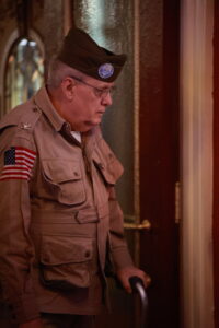 A man in uniform standing next to a door.