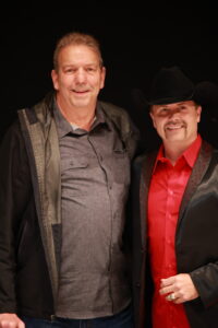 Two men standing next to each other in a room.