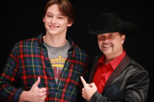 A man and boy posing for the camera.