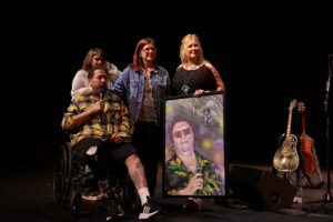 A group of people holding up a picture.